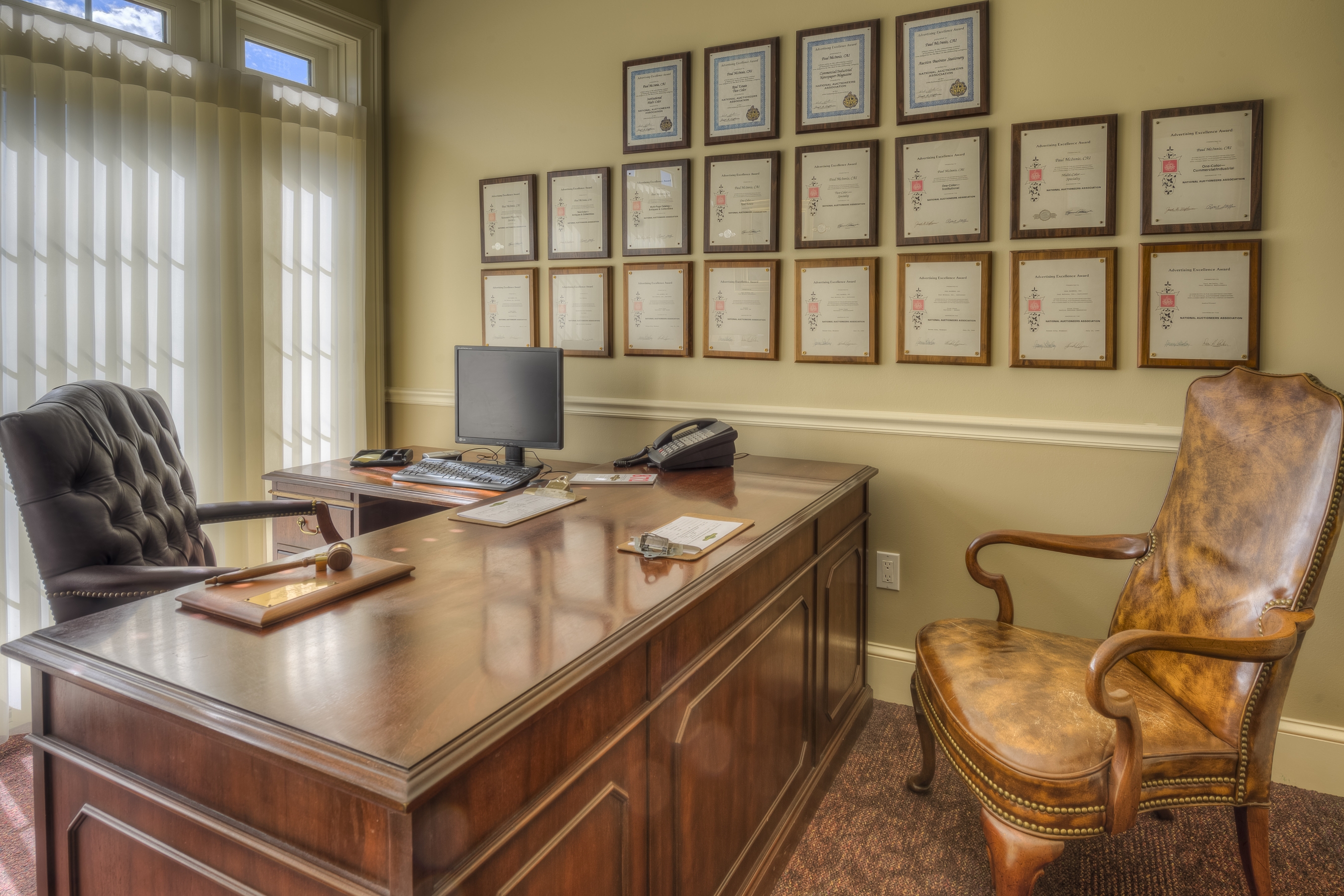 A desk in the Paul McInnis office with awards on the wall
